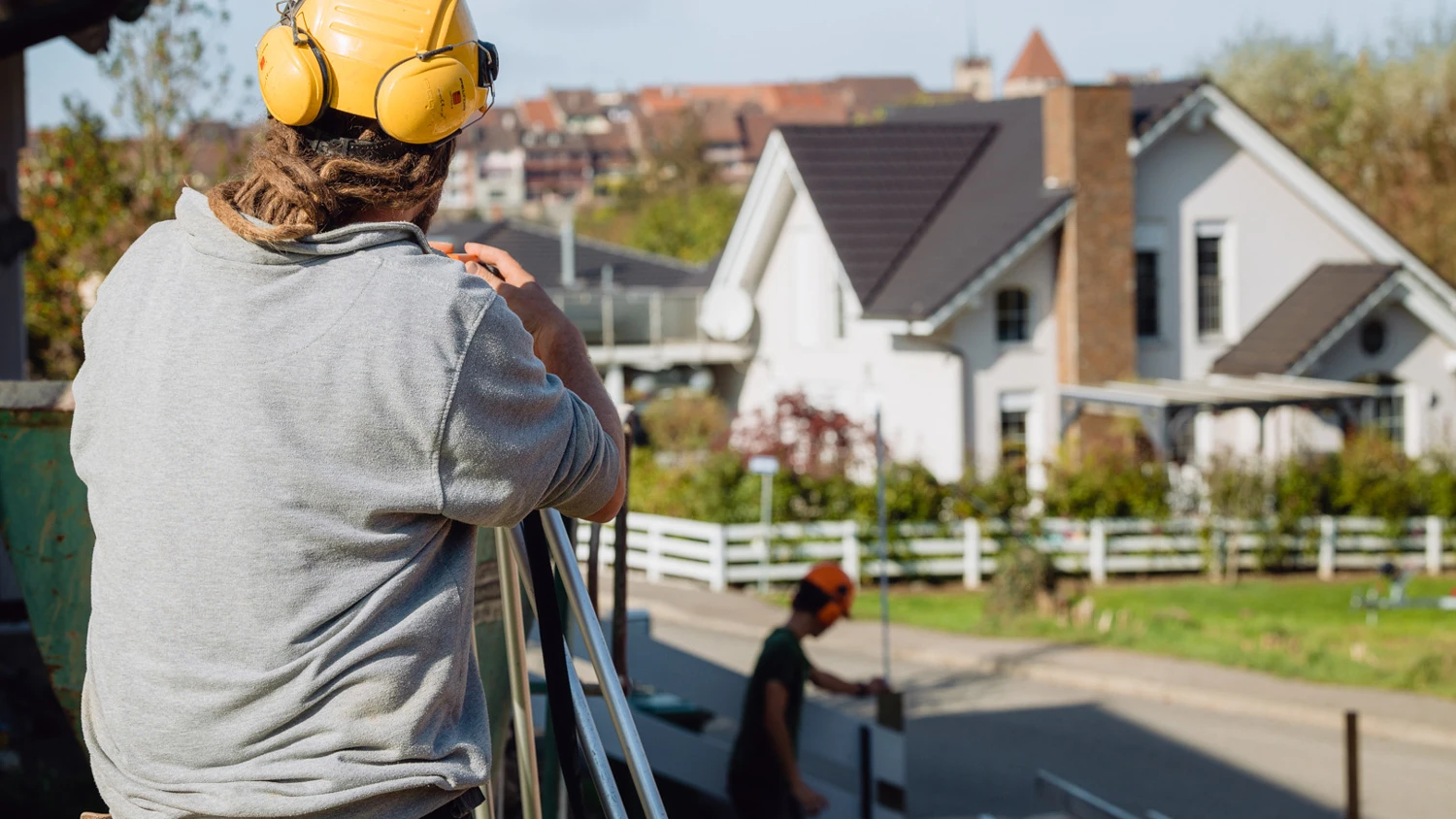 Maître d'apprentissage vérifiant le niveau du terrain avec son apprenti.